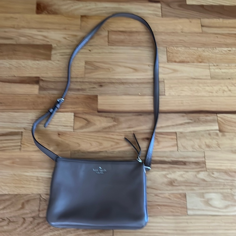 Kate Spade purse with 3 compartments and a zipper.